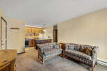 This cozy living space features two plaid sofas, perfect for relaxing.