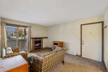 Cozy up in this charming living room featuring a brick fireplace, perfect for those chilly evenings.