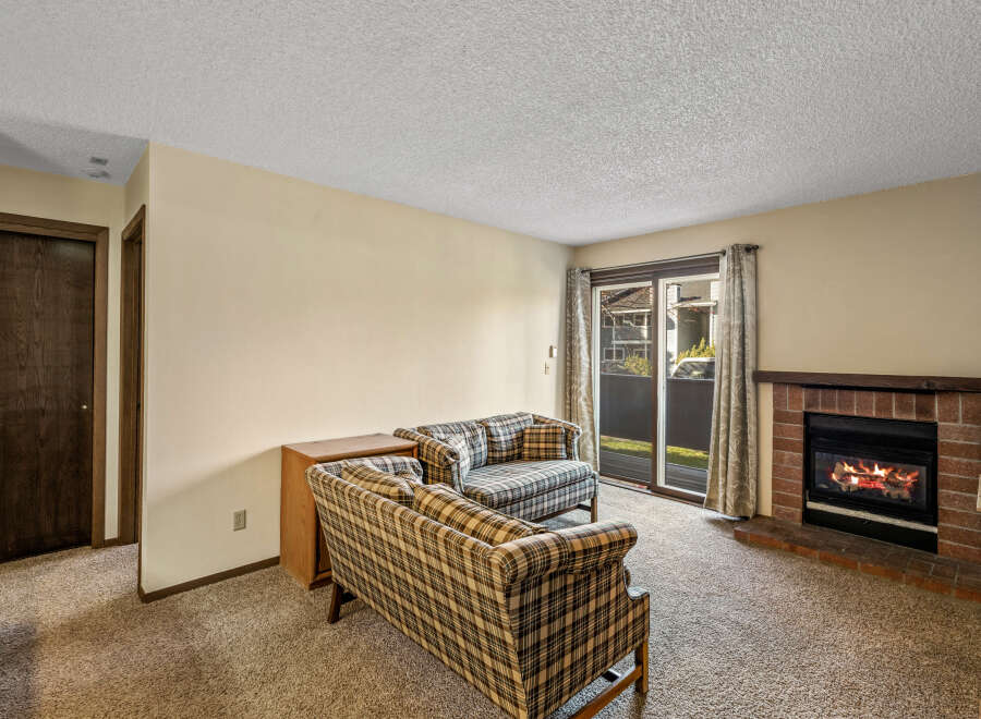 Cozy up in this inviting living room featuring a charming fireplace, perfect for those chilly evenings.