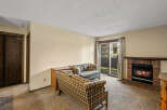Cozy up in this inviting living room featuring a charming fireplace, perfect for those chilly evenings.