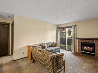 Cozy up in this inviting living room featuring a charming fireplace, perfect for those chilly evenings.