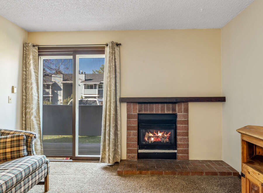 Cozy up in this charming living space featuring a warm fireplace, perfect for those chilly evenings.