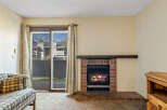 Cozy up in this charming living space featuring a warm fireplace, perfect for those chilly evenings.