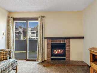 Cozy up in this charming living space featuring a warm fireplace, perfect for those chilly evenings.