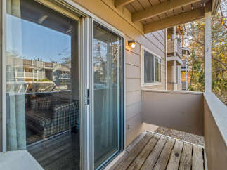 Enjoy the fresh air and stunning views from this charming balcony! This property features a cozy seating area, perfect for relaxing or entertaining.