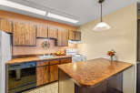 This charming kitchen boasts classic wooden cabinetry and a functional layout, perfect for everyday living.