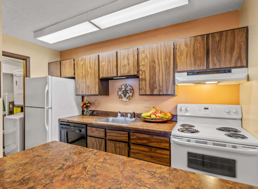 This charming kitchen boasts ample cabinet space and a functional layout, perfect for culinary enthusiasts.