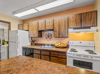 This charming kitchen boasts ample cabinet space and a functional layout, perfect for culinary enthusiasts.
