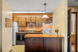 Step into this inviting kitchen, featuring warm wood cabinetry and a functional layout.