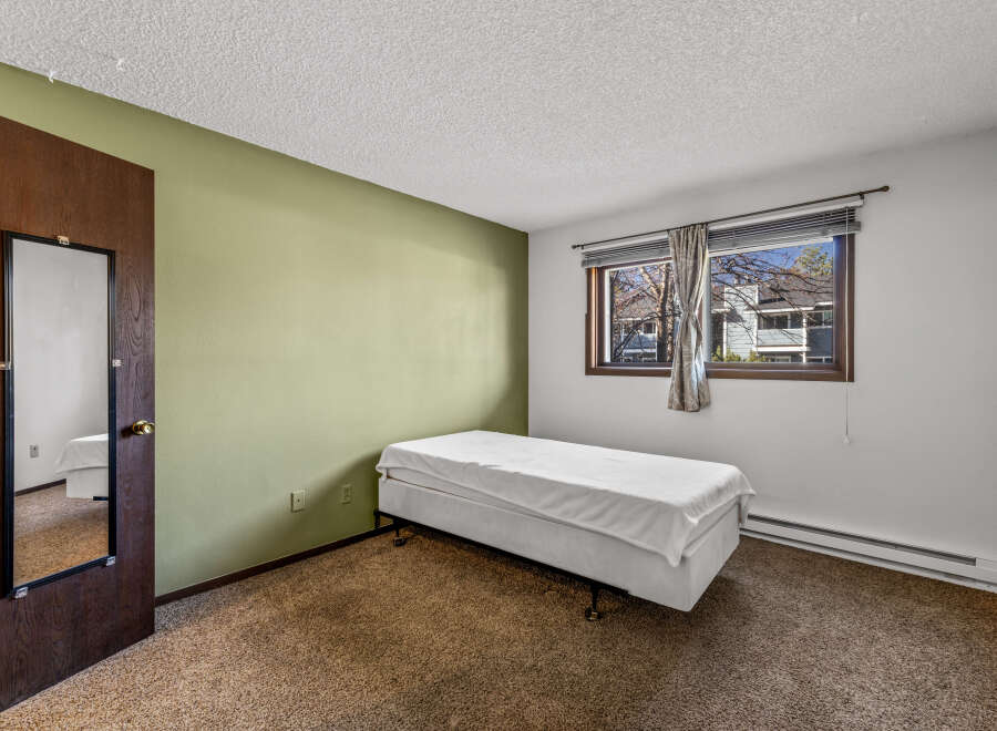 This cozy bedroom features a comfortable bed, perfect for a relaxing night's sleep.
