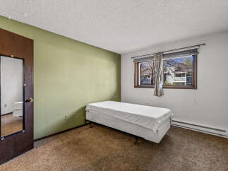 This cozy bedroom features a comfortable bed, perfect for a relaxing night's sleep.