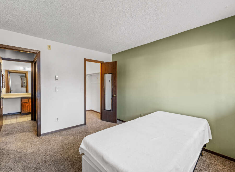 Discover this inviting bedroom featuring a comfortable bed and a soothing color palette.