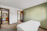 Discover this inviting bedroom featuring a comfortable bed and a soothing color palette.