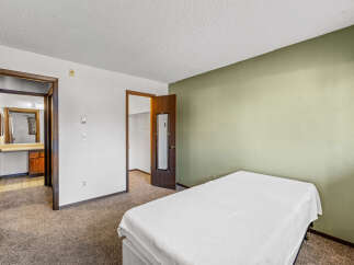 Discover this inviting bedroom featuring a comfortable bed and a soothing color palette.
