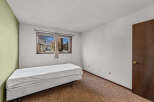 This cozy bedroom features a comfortable bed and a large window that lets in plenty of natural light.