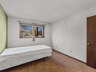 This cozy bedroom features a comfortable bed and a large window that lets in plenty of natural light.