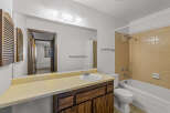 This bathroom features a classic design with a vanity, sink, and a mirror.