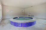 Enjoy a relaxing soak in this inviting spa, perfect for unwinding after a long day.
