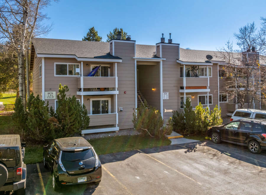 Discover this charming condo complex featuring a neutral exterior and well-maintained landscaping.
