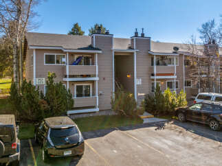 Discover this charming condo complex featuring a neutral exterior and well-maintained landscaping.
