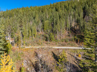 Nestled in a serene mountain landscape, this property offers a unique blend of natural beauty and modern living.