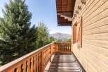 Enjoy breathtaking mountain views from this charming wooden chalet.