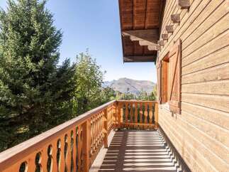 Enjoy breathtaking mountain views from this charming wooden chalet.