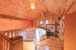 This cozy loft space features warm wooden paneling throughout, creating a welcoming atmosphere.