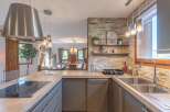 This stunning kitchen boasts a modern design with sleek cabinetry and a beautiful stone backsplash.