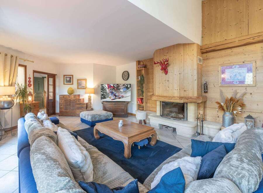 Experience the warmth of this inviting living room, featuring a cozy fireplace and rustic wooden accents.