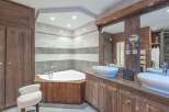 Experience luxury in this stunning bathroom! Featuring a sleek, modern design with a corner bathtub and a double vanity, this space is perfect for relaxation.