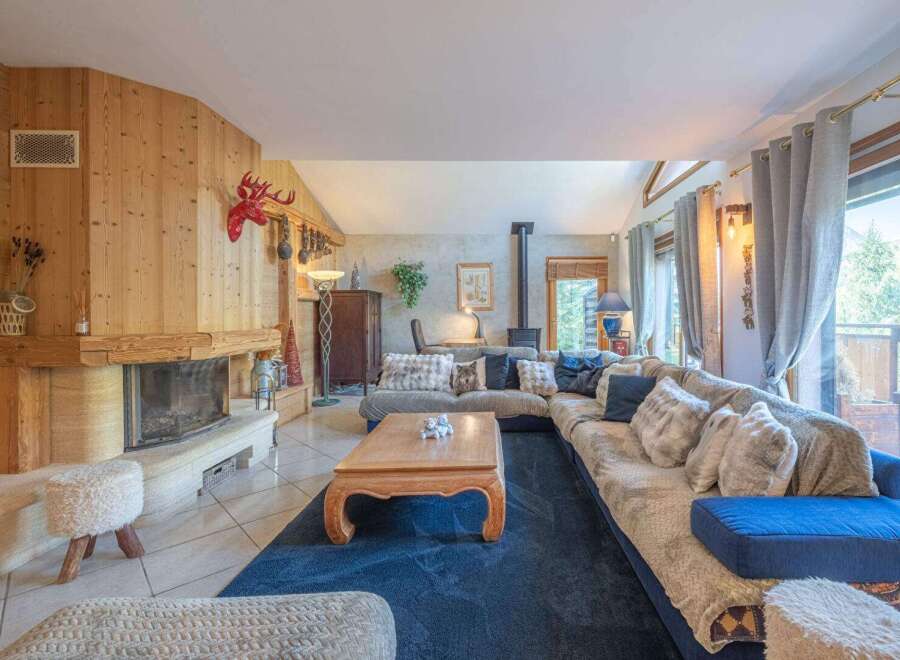 Step into this inviting living space, featuring a cozy fireplace and a spacious, comfortable sectional sofa.