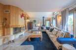 Step into this inviting living space, featuring a cozy fireplace and a spacious, comfortable sectional sofa.