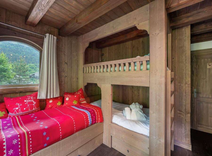 Step into a cozy retreat with this charming bedroom, featuring a unique bunk bed design.