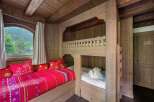Step into a cozy retreat with this charming bedroom, featuring a unique bunk bed design.
