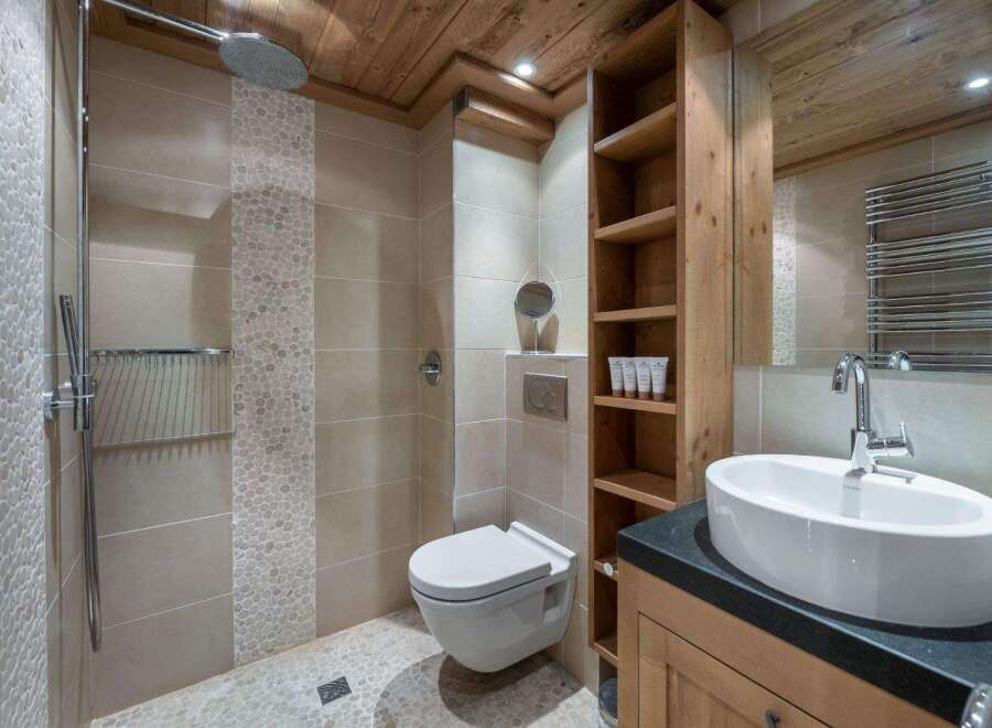 This luxurious bathroom features a stunning combination of natural wood and modern design.