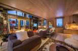 This stunning living room boasts a cozy and inviting atmosphere, perfect for relaxing after a day on the slopes.