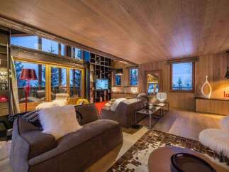 This stunning living room boasts a cozy and inviting atmosphere, perfect for relaxing after a day on the slopes.