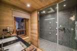Step into luxury with this stunning bathroom featuring a modern shower and elegant double sinks.
