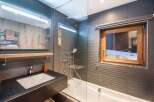 This modern bathroom features a sleek design with a combination of functionality and style.