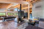 Experience luxury living in this stunning property, featuring a spacious open-plan design with exposed wooden beams and a cozy fireplace.