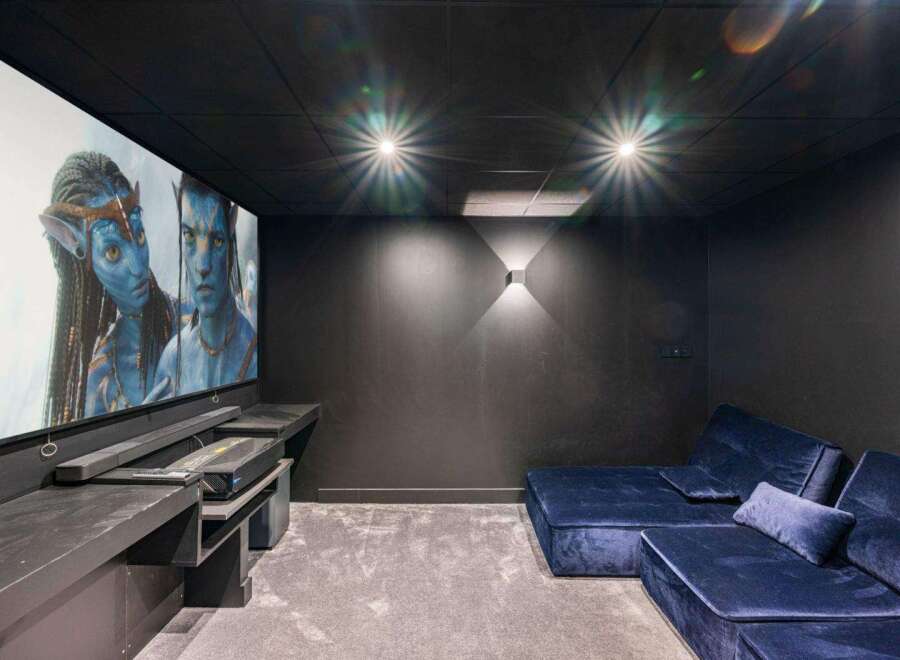 Step into luxury with this stunning home theater! Featuring a large screen, comfortable seating, and a state-of-the-art projector, this space is perfect for movie nights.