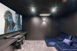 Step into luxury with this stunning home theater! Featuring a large screen, comfortable seating, and a state-of-the-art projector, this space is perfect for movie nights.