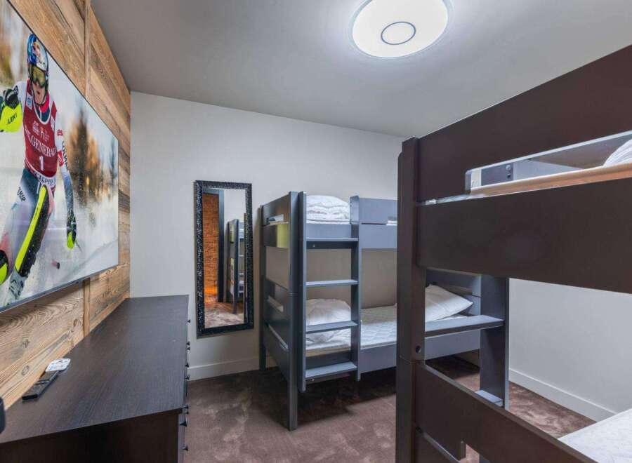 This cozy bedroom features bunk beds, perfect for accommodating guests or family members.
