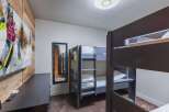 This cozy bedroom features bunk beds, perfect for accommodating guests or family members.