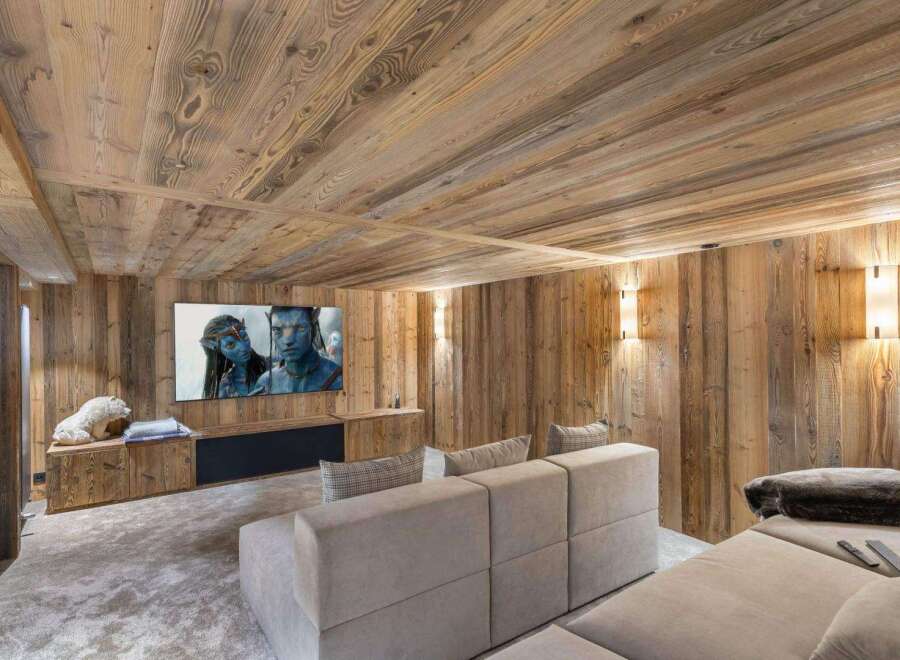 Experience luxury in this stunning home theater, featuring exquisite wood paneling and a cozy, inviting atmosphere.
