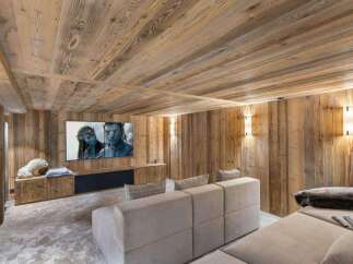 Experience luxury in this stunning home theater, featuring exquisite wood paneling and a cozy, inviting atmosphere.
