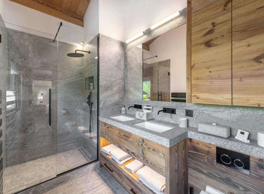 Experience luxury in this stunning bathroom, featuring a sleek glass shower and elegant double vanity.