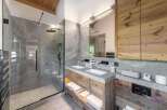 Experience luxury in this stunning bathroom, featuring a sleek glass shower and elegant double vanity.