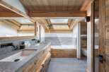 Experience luxury in this stunning bathroom featuring a rustic wooden design.